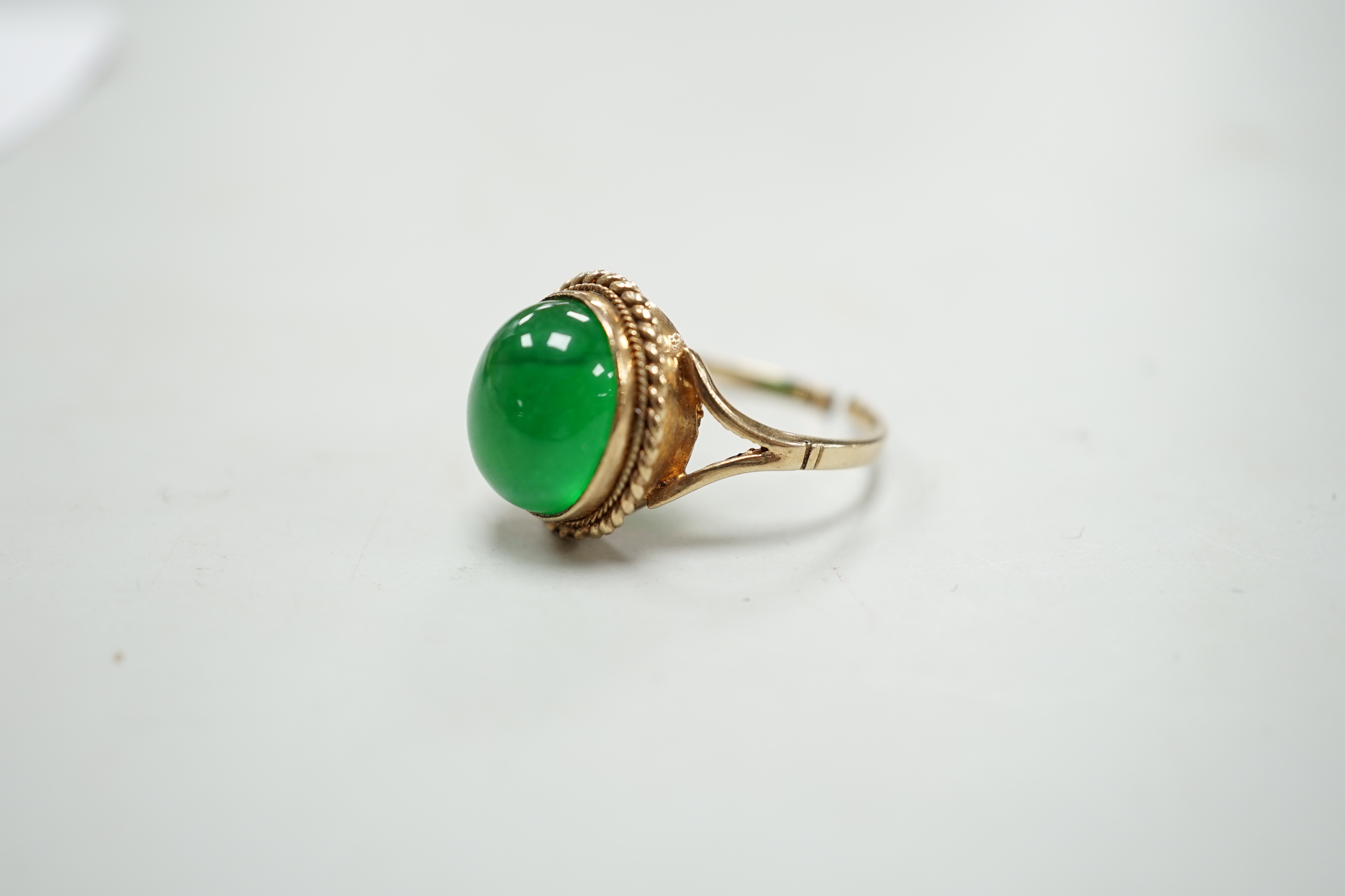 A 9ct gold and cabochon jade set oval ring (shank cut), gross weight 4.3 grams.